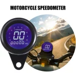 Illuminated black digital gauge at night with indicator lights